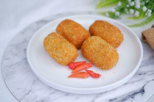 Fried croquettes on a white plate. Selective focus. photo