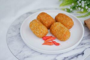 Fried croquettes on a white plate. Selective focus. photo