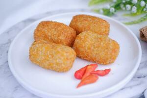 Fried croquettes on a white plate. Selective focus. photo