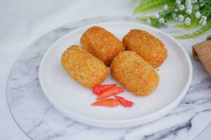 Fried croquettes on a white plate. Selective focus. photo