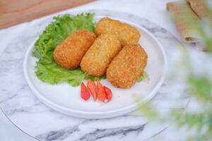 Fried croquettes on a white plate. Selective focus. photo