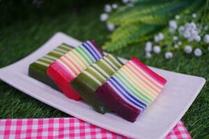 Kue Lapis or or Rainbow sticky layer cake, Indonesian traditional dessert made from rice flour and coconut milk, steamed layer by layer. Selective focus. photo