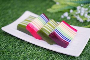 Kue Lapis or or Rainbow sticky layer cake, Indonesian traditional dessert made from rice flour and coconut milk, steamed layer by layer. Selective focus. photo