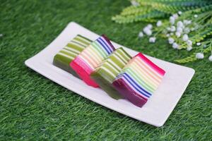 Kue Lapis or or Rainbow sticky layer cake, Indonesian traditional dessert made from rice flour and coconut milk, steamed layer by layer. Selective focus. photo