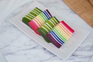 Kue Lapis or or Rainbow sticky layer cake, Indonesian traditional dessert made from rice flour and coconut milk, steamed layer by layer. Selective focus. photo