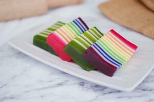 Kue Lapis or or Rainbow sticky layer cake, Indonesian traditional dessert made from rice flour and coconut milk, steamed layer by layer. Selective focus. photo