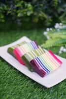 Kue Lapis or or Rainbow sticky layer cake, Indonesian traditional dessert made from rice flour and coconut milk, steamed layer by layer. Selective focus. photo
