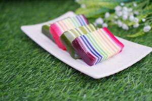 Kue Lapis or or Rainbow sticky layer cake, Indonesian traditional dessert made from rice flour and coconut milk, steamed layer by layer. Selective focus. photo