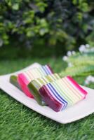 Kue Lapis or or Rainbow sticky layer cake, Indonesian traditional dessert made from rice flour and coconut milk, steamed layer by layer. Selective focus. photo