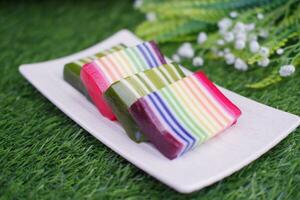 Kue Lapis or or Rainbow sticky layer cake, Indonesian traditional dessert made from rice flour and coconut milk, steamed layer by layer. Selective focus. photo