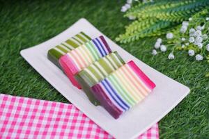Kue Lapis or or Rainbow sticky layer cake, Indonesian traditional dessert made from rice flour and coconut milk, steamed layer by layer. Selective focus. photo
