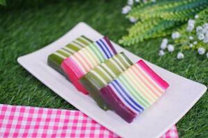 Kue Lapis or or Rainbow sticky layer cake, Indonesian traditional dessert made from rice flour and coconut milk, steamed layer by layer. Selective focus. photo