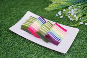Kue Lapis or or Rainbow sticky layer cake, Indonesian traditional dessert made from rice flour and coconut milk, steamed layer by layer. Selective focus. photo
