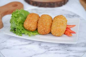 Fried croquettes on a white plate. Selective focus. photo