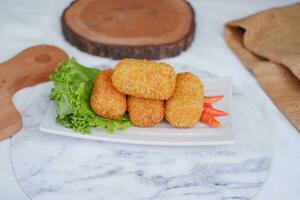 Fried croquettes on a white plate. Selective focus. photo