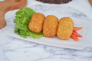 Fried croquettes on a white plate. Selective focus. photo