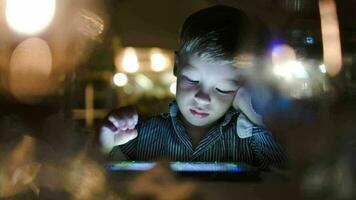 Boy playing on tablet computer in cafe video