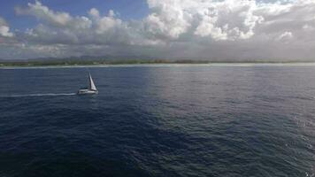 Sailing yacht and island coast, aerial shot video