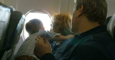 Grandparents and little grandson traveling by plane video