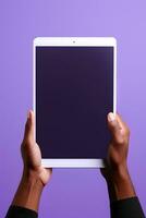 Hand holding tablet with mockup blank screen isolated on purple background. ai generated photo