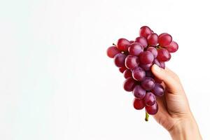 Hand holding a bunch of red grapes isolated on a white background with copy space. ai generated photo