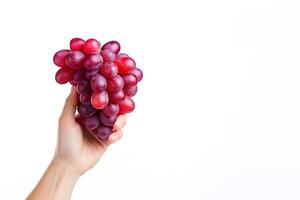 Hand holding a bunch of red grapes isolated on a white background with copy space. ai generated photo