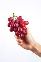 Hand holding a bunch of red grapes isolated on a white background. ai generated photo