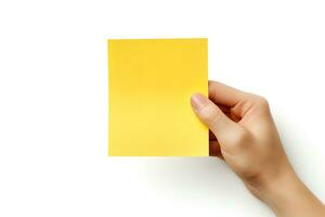 A human hand holding a blank sheet of yellow paper or card isolated on white background. ai generated photo