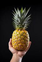 Hand hold fresh pineapple isolated on a black background. ai generated photo