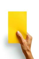 A human hand holding a blank sheet of yellow paper or card isolated on white background. ai generated photo