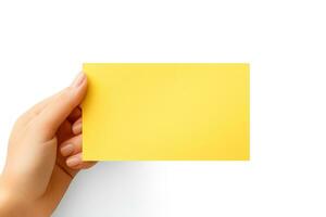 A human hand holding a blank sheet of yellow paper or card isolated on white background. ai generated photo