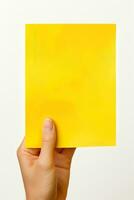 A human hand holding a blank sheet of yellow paper or card isolated on white background. ai generated photo