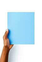 A human hand holding a blank sheet of blue paper or card isolated on white background. ai generated photo