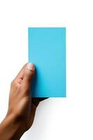 A human hand holding a blank sheet of blue paper or card isolated on white background. ai generated photo