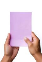 A human hand holding a blank sheet of purple paper or card isolated on a white background. ai generated photo