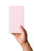 A human hand holding a blank sheet of pink paper or card isolated on a white background. ai generated photo