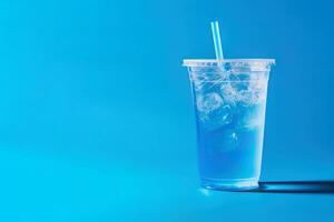 Blue drink in a plastic cup isolated on a blue background. Take away drinks concept with copy space. ai generated photo