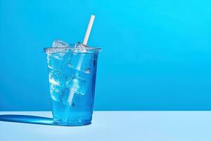 Blue drink in a plastic cup isolated on a blue background. Take away drinks concept with copy space. ai generated photo