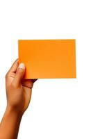 A human hand holding a blank sheet of orange paper or card isolated on a white background. ai generated photo