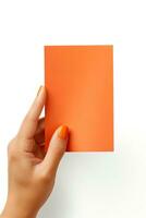 A human hand holding a blank sheet of orange paper or card isolated on a white background. ai generated photo