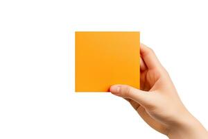 A human hand holding a blank sheet of orange paper or card isolated on a white background. ai generated photo