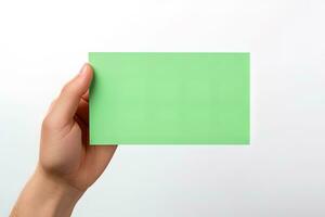 A human hand holding a blank sheet of green paper or card isolated on a white background. ai generated photo