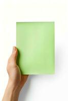 A human hand holding a blank sheet of green paper or card isolated on a white background. ai generated photo