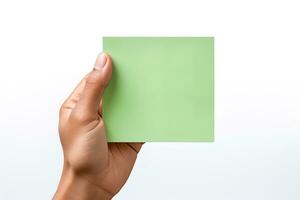 A human hand holding a blank sheet of green paper or card isolated on a white background. ai generated photo