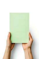 A human hand holding a blank sheet of green paper or card isolated on a white background. ai generated photo