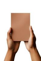 A human hand holding a blank sheet of brown paper or card isolated on a white background. ai generated photo