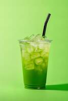 Green drink in a plastic cup isolated on a green background. Take away drinks concept. ai generated photo