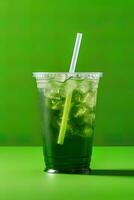 Green drink in a plastic cup isolated on a green background. Take away drinks concept. ai generated photo