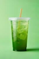 Green drink in a plastic cup isolated on a green background. Take away drinks concept. ai generated photo