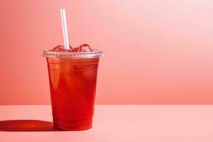 rojo bebida en un el plastico taza aislado en un rojo pastel antecedentes. tomar lejos bebidas concepto con Copiar espacio. ai generado foto